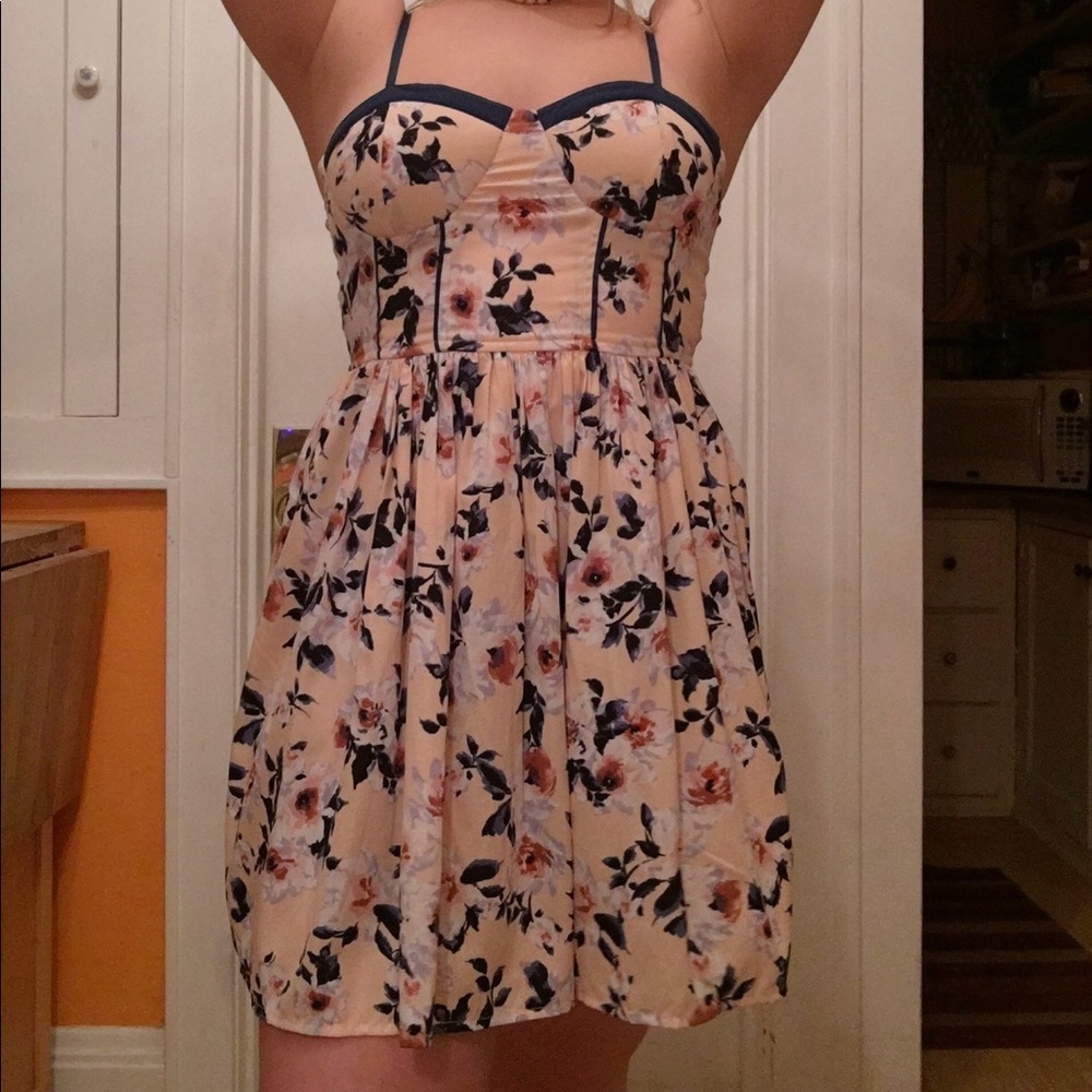 A nude pink casual-formal dress with floral print